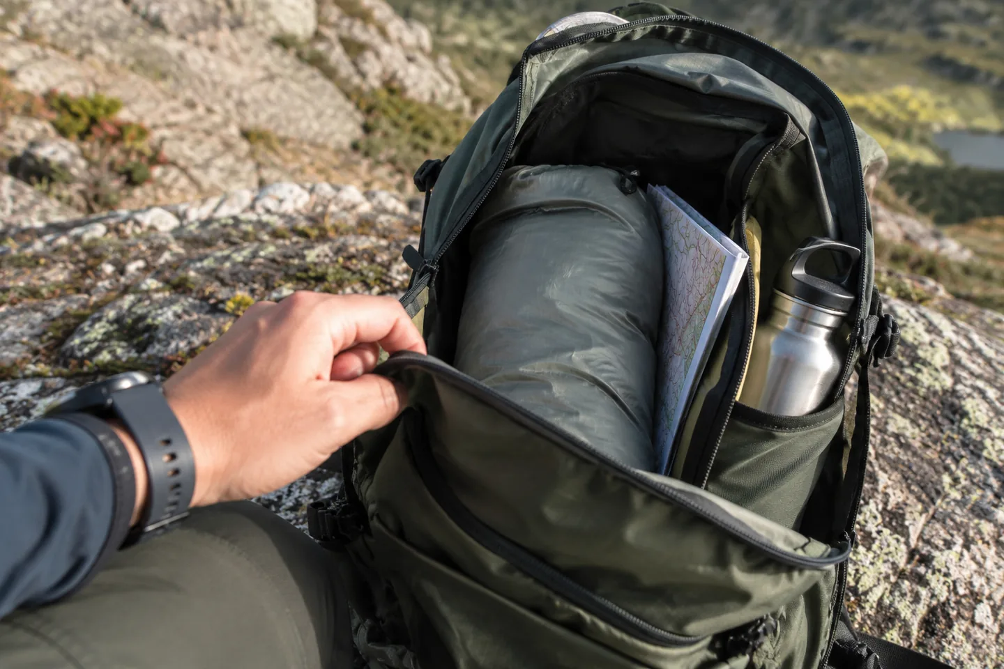 Open daypack with protected spare layer